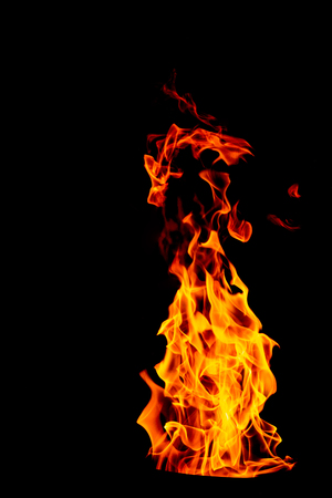 Fire flame on black isolated background - Beautiful yellow, orange and red and red blaze fire flame texture style.の写真素材
