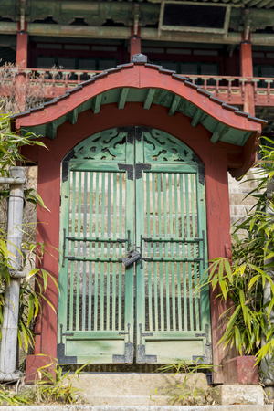 Architectural detail - Korean Tradition Green Wooden door and red wood frame door, decoration ancient korean Changdeokgung - Secret Gardenin Seoul, republic of Korea / south koreaの写真素材