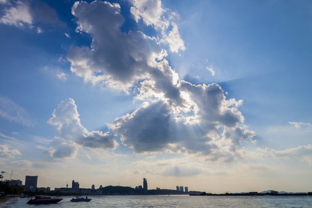speed boat floating on blue sea with blue sky with rays of light shining down pass clouds,Tropical...