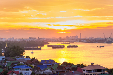 Chao Phraya river and Morning light reflections in the river in Bangkok landscape, with panorama cityscale with sunrise / sunset, light yellow and orange sky andの写真素材