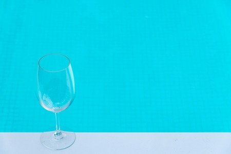 Put Empty wine glass in party luxury hotel with the blue sky pool backgroundの写真素材