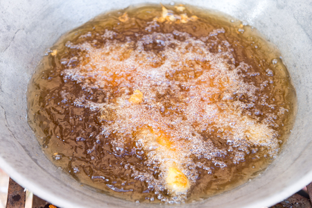 Boiling oil in the pan for fried foodの写真素材