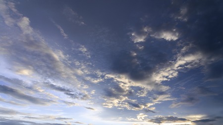 sunset / sun rise sky with rays of yellow and red light shining clouds and sky background and textureの写真素材
