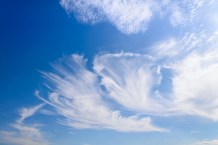 Blue sky with close up white fluffy tiny clouds background and patternの写真素材