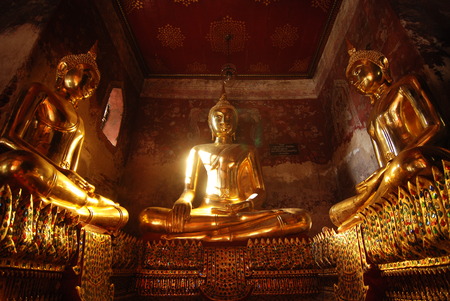 Gold classic buddha statue in terrace of Suthatthepphaararam temple (wat Suthat), Bangkok, Thailand.の写真素材