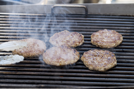 Grilled meat / pork burgers, grill, smoke and light aroma - Cooking grill burgers processの写真素材