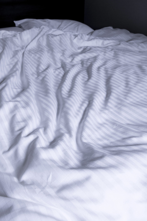 Top view of white bedding striped textile, Elegant textile on bedの写真素材