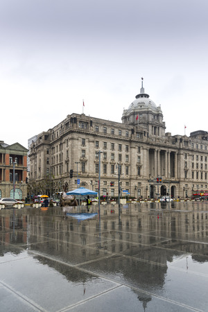 SHANGHAI, CHINA - December 28, 2017: Historical architecture on the bund of Shanghai with reflection of buildings on rain, waterfront of the Huangpu River is a popular tourist destination of Asia. Shanghai, Chinaのeditorial素材