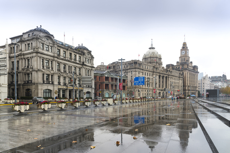 SHANGHAI, CHINA - December 28, 2017: Historical architecture on the bund of Shanghai with reflection of buildings on rain, waterfront of the Huangpu River is a popular tourist destination.Chinaのeditorial素材