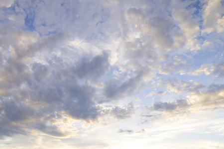sunset / sun rise sky with light yellow and orange light shining clouds and sky background and textureの写真素材