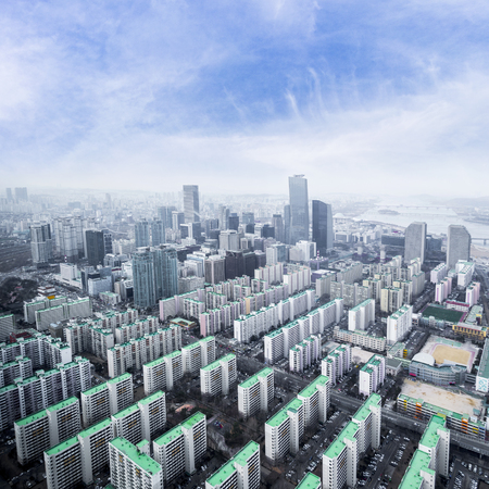 Seoul cityscapes, skyline, high rise office buildings and skyscrapers in Seoul city, winter daylight, top view in winter, Seoul, Republic of Korea, in mist winter season with blue sky and cloudの写真素材