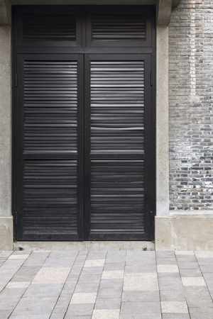 Traditional classic wood door and brick wall in ancient chinese house, shanghai city, chinaの写真素材