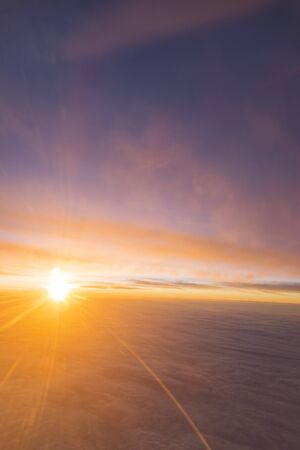the sea of cloud sunset sky background from window airplaneの写真素材