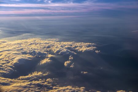 the sea of cloud sunset sky background from window airplaneの写真素材