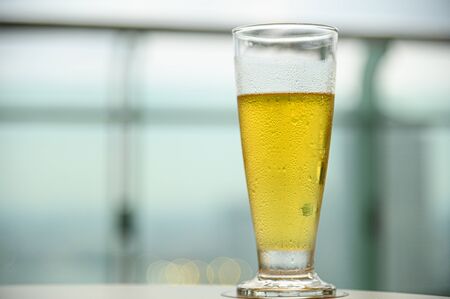 Ice beer on glass with blue sky natural background
