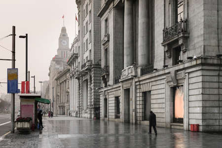 SHANGHAI, CHINA - December 31, 2017: Historical architecture on the bund of Shanghai with reflection of buildings on rain and mist in city, the Bund is a popular tourist destination of Shanghai, Chinaのeditorial素材