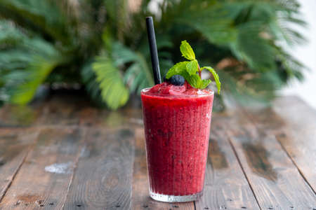 Fresh Blueberry smoothies  in glass  on wood table backgroundの写真素材