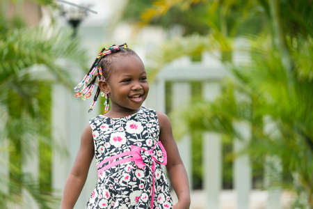 portrait of cute young african girl playing  funny in outdoor garden.
