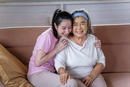Asian young woman take care and  support with hug, that make feel good and smile older mother in...