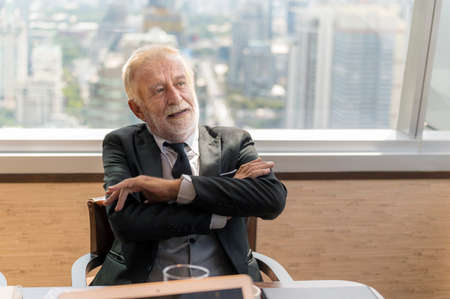 Portrait of happy businessman having meeting to success deal business at skyscraper office with cityscape business zone backgroundの写真素材