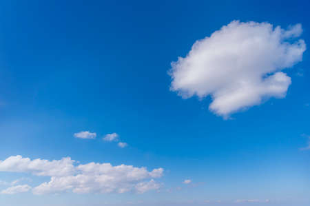Blue sky and white fluffy tiny clouds background and patternの写真素材
