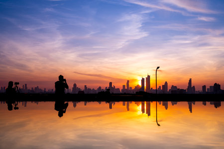 cityscape of Bangkok city skyline silhouette and reflextion  on glass top table with sunset sky background, Bangkok city is modern metropolis of Thailand and favorite of touristsの写真素材