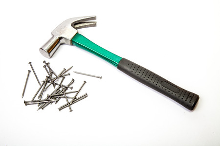 Green hammer with wood nails on white backgroundの写真素材