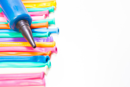 balloon twisting colorful,rainbow,long with pump on white background with copy space for your textの写真素材