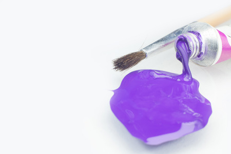 Bright purple Acrylic paint, extruded from the tube. On a white background, close-up の写真素材