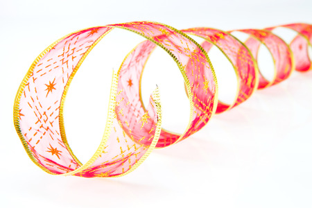 Red curly ribbon on a white backgroundの写真素材