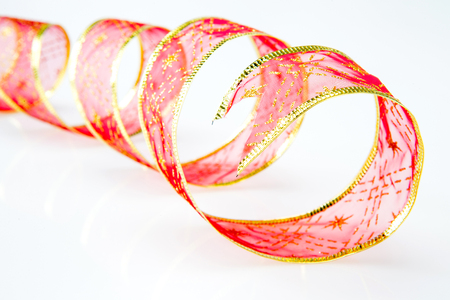 Red curly ribbon on a white backgroundの写真素材