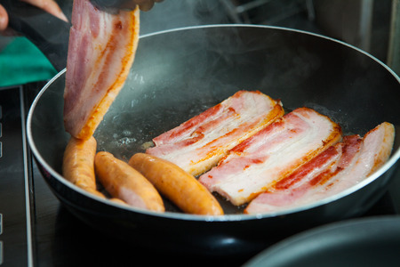 fried pork and sausage cooking in the panの写真素材
