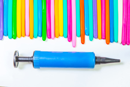 balloon twisting on white background with balloon pump