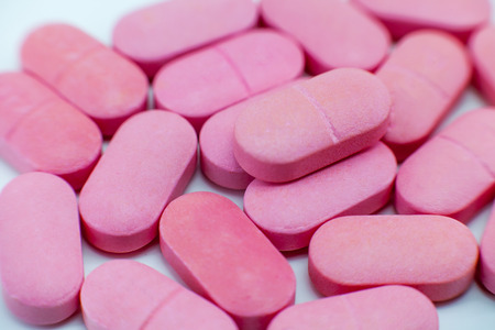 pink pile of tablets vitamins or pills
