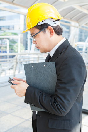 engineer is using the mobile phone digital tabletの写真素材