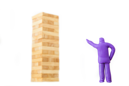 plasticine businessman commanding to blocks wood game or jenga on white backgroundの写真素材