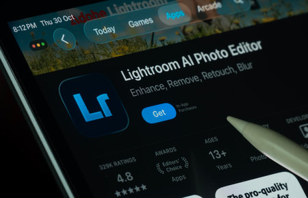 Dhaka, Bangladesh- 30 Oct 2025: Lightroom Ai app displayed on a iPad screen in dark mode with a digital pen pointing at it.のeditorial素材