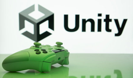 Dhaka, Bangladesh- 14 Nov 2025: A close-up of a white gamepad with the Unity seen on screen in the...