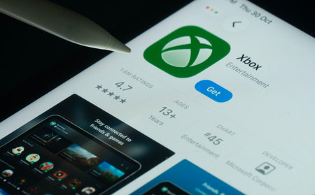 Dhaka, Bangladesh- 30 Oct 2025: Xbox app on a iPad screen with a pen pointing at the install option.のeditorial素材