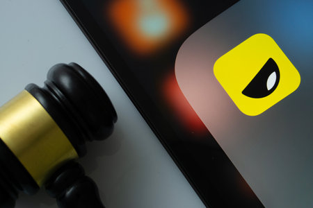 Dhaka, Bangladesh- 16 March 2025: A close up of an iPad screen displaying the Yubo app alongside a judge's gavel.のeditorial素材