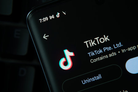 Dhaka, Bangladesh- 27 July 2025: Screen displaying TikTok app with update and uninstall options, dark interfaceのeditorial素材