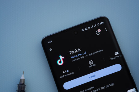 Dhaka, Bangladesh- 29 May 2025: On a blue surface, a smartphone displays the TikTok app within the Google Play Store.のeditorial素材