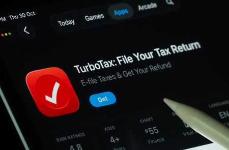 Dhaka, Bangladesh- 30 Oct 2025: TurboTax app displayed on a iPad screen in dark mode with a digital pen pointing at it.のeditorial素材