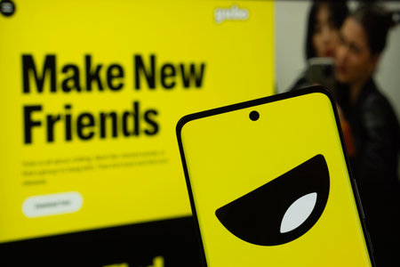 Dhaka, Bangladesh - 18 March 2025: The logo of Yubo is displayed on a smartphone screen, and the website is visible on a computer screen in the background.のeditorial素材