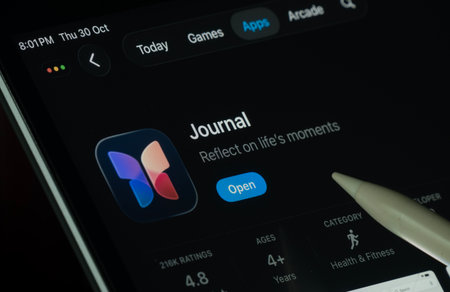 Dhaka, Bangladesh- 30 Oct 2025: Apple Journal app displayed on a iPad screen in dark mode with a digital pen pointing at it.のeditorial素材