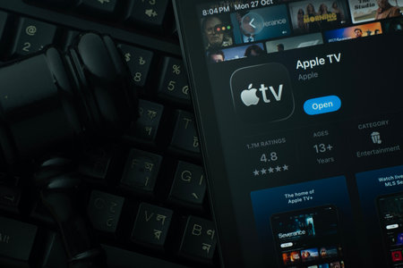Dhaka, Bangladesh- 28 Oct 2025: An iPad displaying the Apple TV app against a judge's gavel and dark keyboard background.のeditorial素材