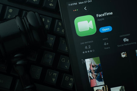 Dhaka, Bangladesh- 28 Oct 2025: An iPad displaying the Apple Facetime app against a judge's gavel and dark keyboard background.のeditorial素材