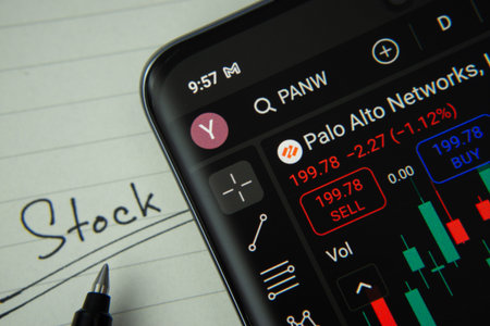 Dhaka, Bangladesh- 20 June 2025: Palo Alto stock trading information on smartphone screen with a handwritten note.のeditorial素材