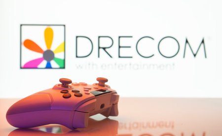 Dhaka, Bangladesh- 13 Sep 2025: A close-up of a white gamepad with the Drecom seen on screen in the...