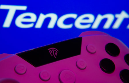 Dhaka, Bangladesh- 12 June 2025: A close-up of a gamepad with the Tencent seen on screen in the background.のeditorial素材